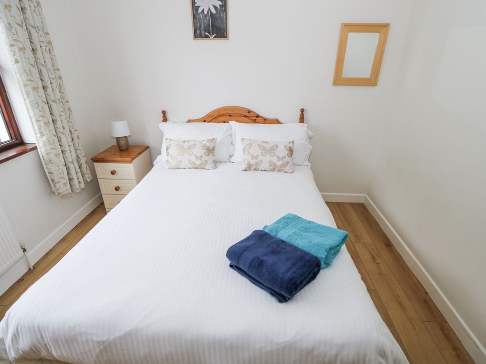 A bedroom with a bed and bedside table at Brow O' The Hill in Ballyshannon
