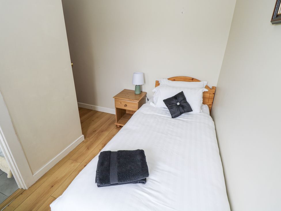 A bedroom with a single bed and nightstand at Brow O' The Hill in Ballyshannon
