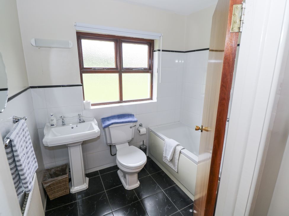 A bathroom with a toilet, sink, and bathtub at Brow O' The Hill in Ballyshannon