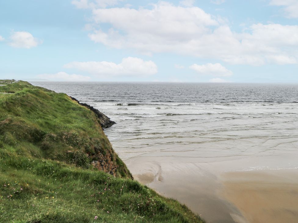 A coastal view with grass and sand at Brow O' The Hill in Ballyshannon