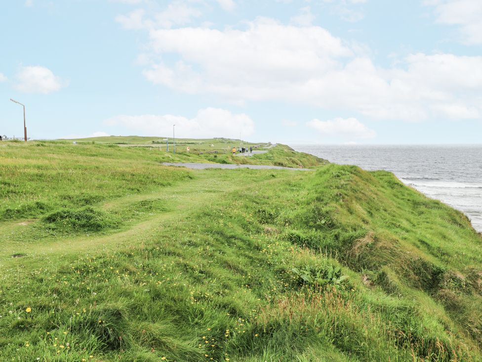 A coastal view with grass and a road at Brow O' The Hill in Ballyshannon