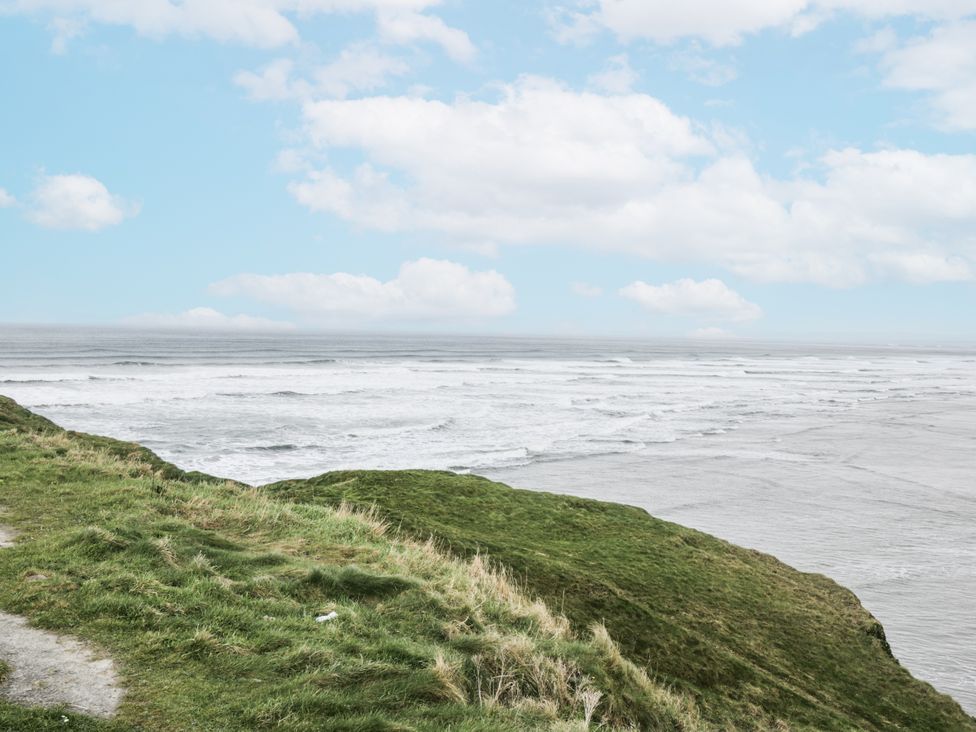 A view of the ocean with waves from a grassy cliff at Brow O' The Hill in Ballyshannon
