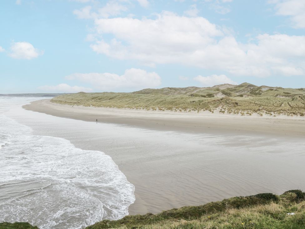 A beach scene with waves and sand dunes at Brow O' The Hill in Ballyshannon