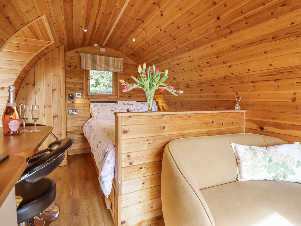A bedroom with a bed and a small table at The Rhiw in Llanfair Caereinion
