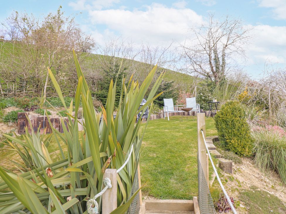 A garden with chairs and a table at The Rhiw in Llanfair Caereinion