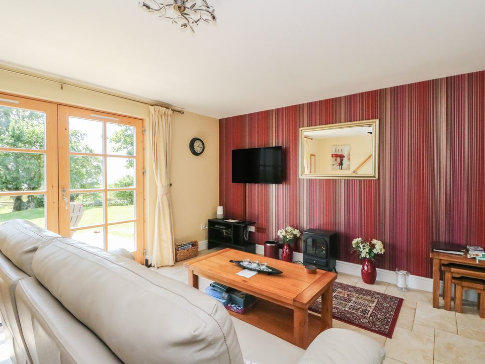 A living room with a sofa and television at Ettrick Cottage in Rothesay