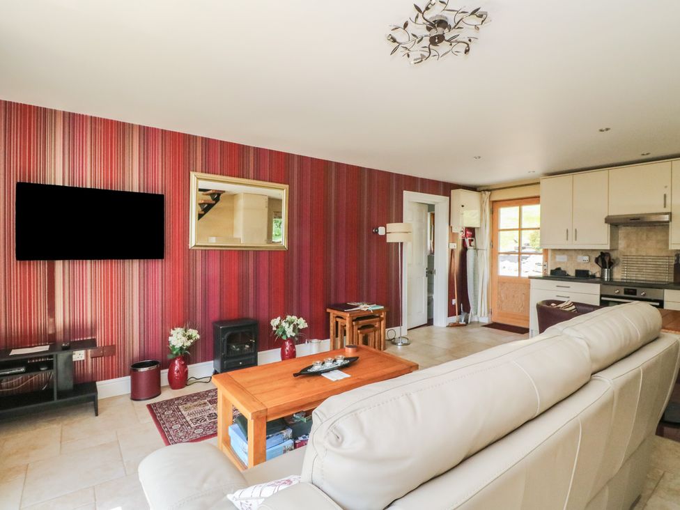 A living room with a sofa and coffee table at Ettrick Cottage in Rothesay