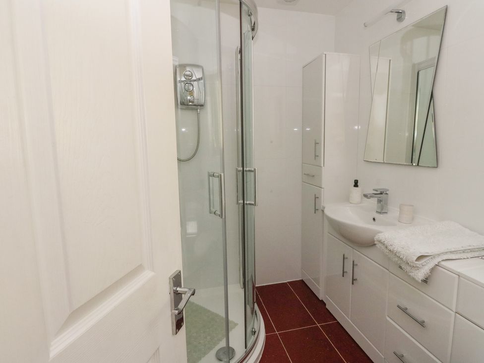 A bathroom with a shower and sink at Ettrick Cottage in Rothesay