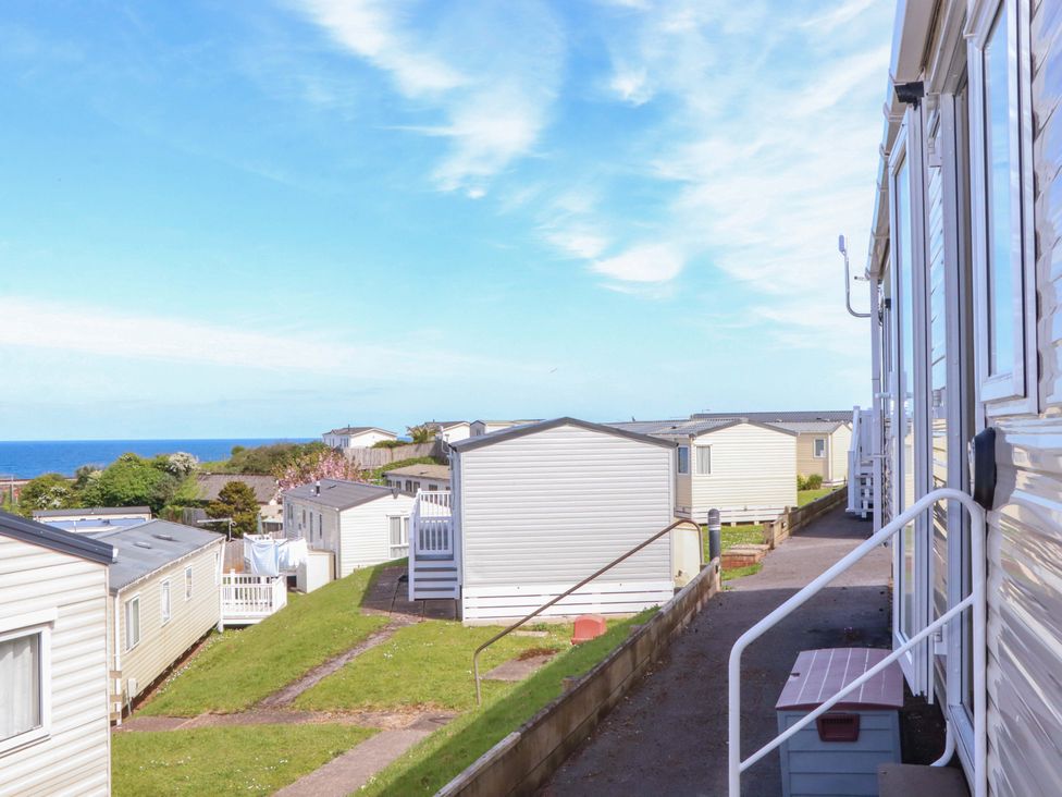 An outdoor area with caravans and a pathway at 213 Seaview Caravan