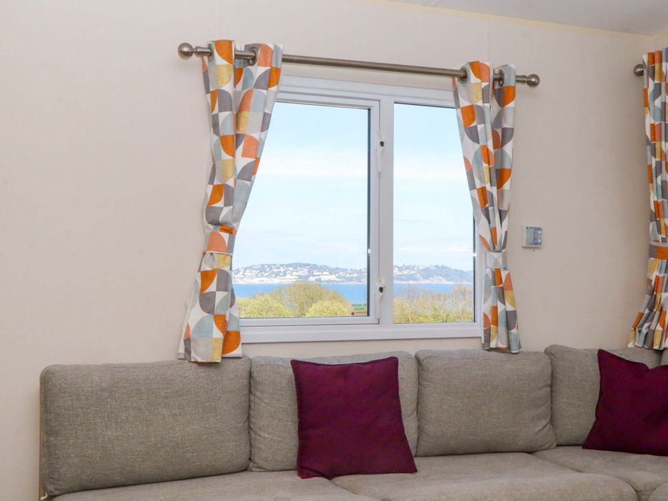 A living room with a window and a sofa at 213 Seaview Caravan
