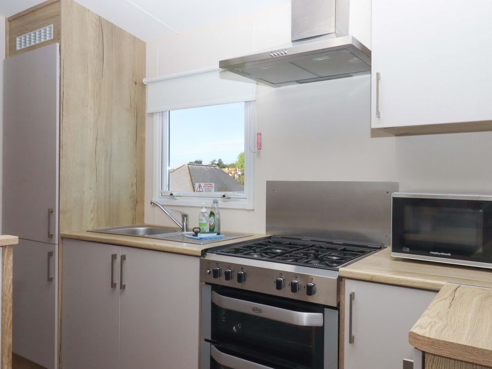 A kitchen with a sink and oven at 213 Seaview Caravan