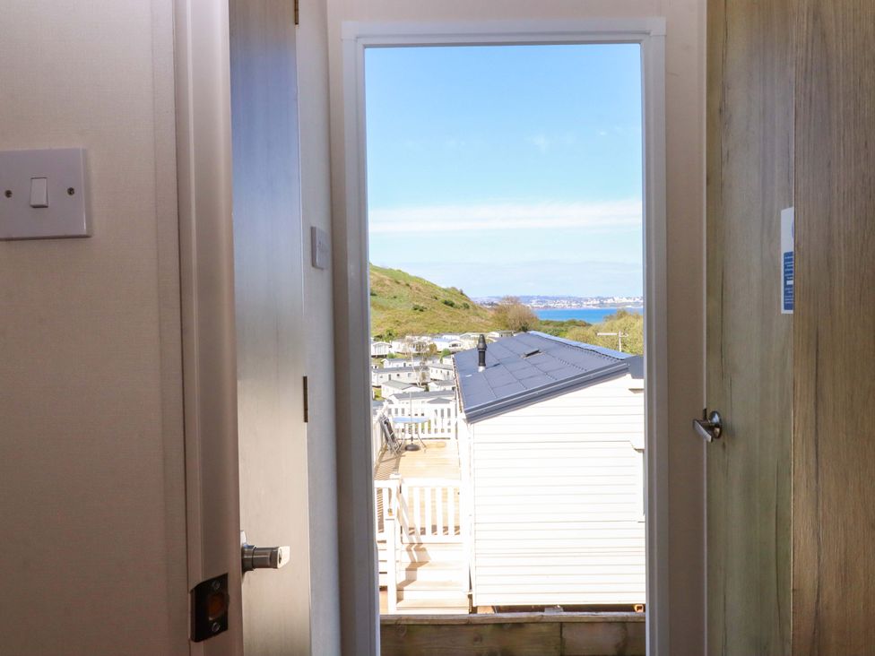 A hallway with a view of the landscape and sea at 213 Seaview Caravan