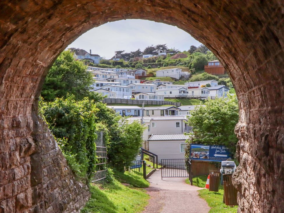 A view of holiday homes through a stone archway at 213 Seaview Caravan