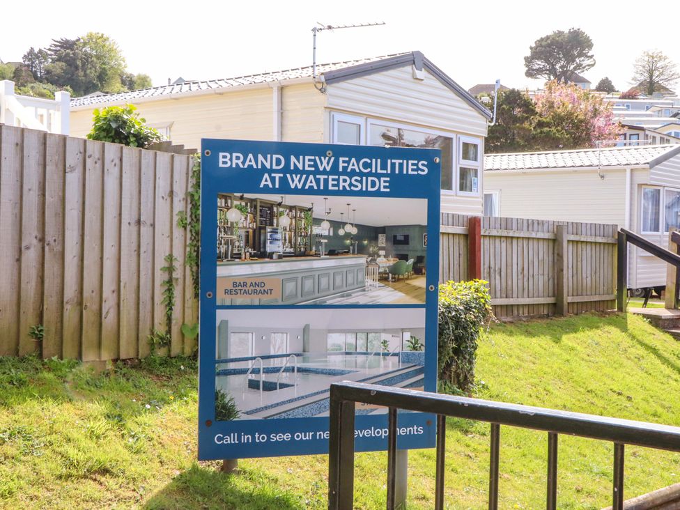 A sign advertising new facilities at Waterside including a bar, restaurant, and pool