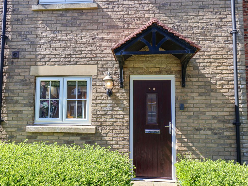 An entrance with a door and window at Driftwood in Filey