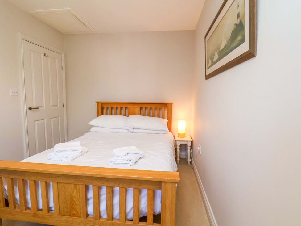 A bedroom with a bed and lamp at Driftwood in Filey