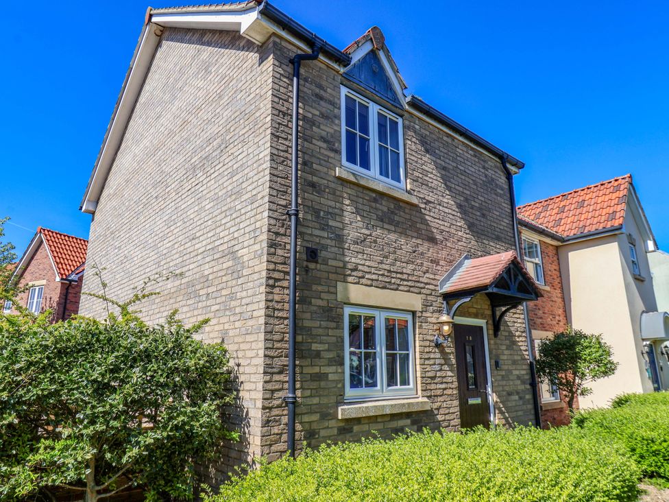 A house with multiple windows and a door at Driftwood in Filey