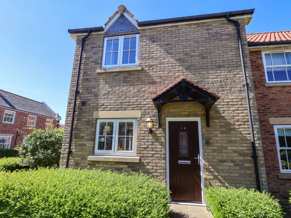 A house exterior featuring a front door and windows at Driftwood Filey