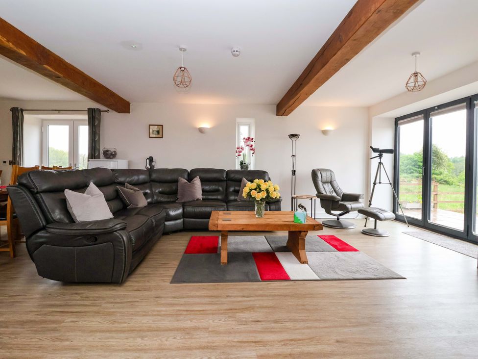A living room with a sofa and coffee table at Ploughman's Rigg in Follifoot near Spofforth