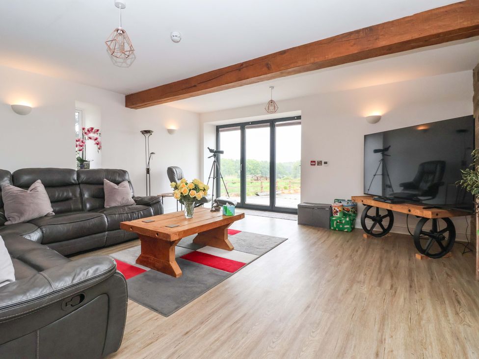 A living room with a sofa and coffee table at Ploughman's Rigg in Follifoot near Spofforth