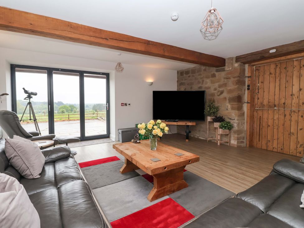 A living room with a coffee table and tv at Ploughman's Rigg in Follifoot near Spofforth