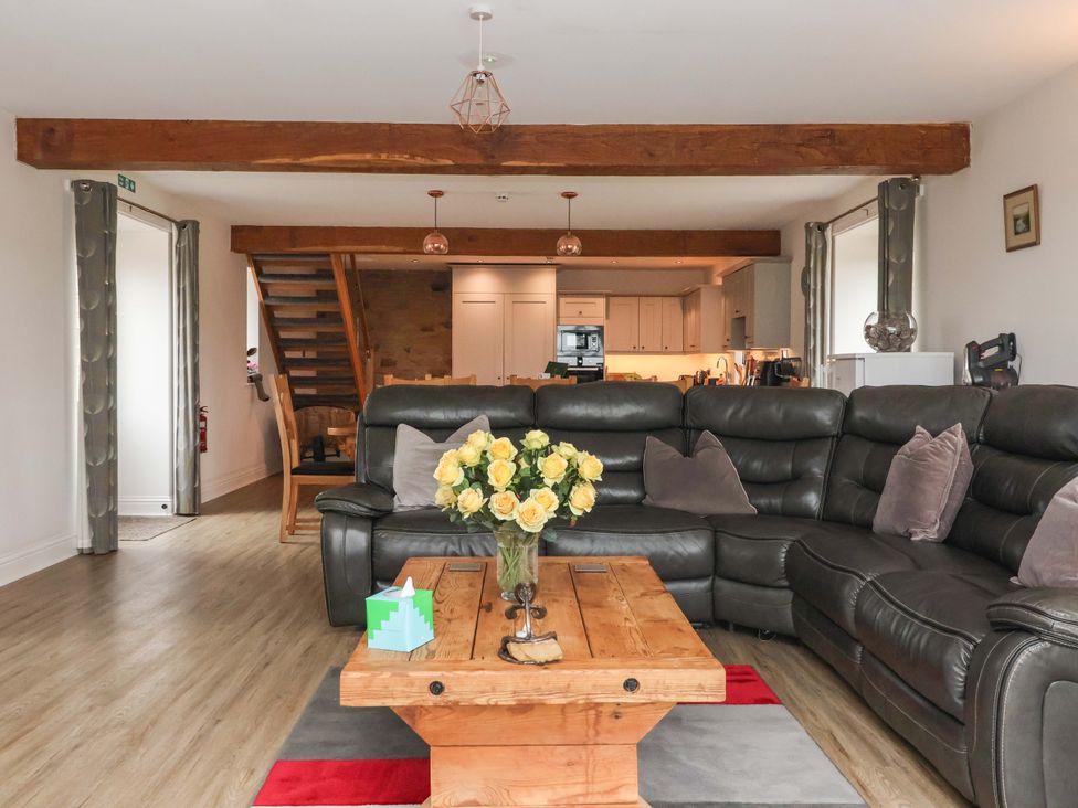 A living room with a sofa and coffee table at Ploughman's Rigg in Follifoot near Spofforth