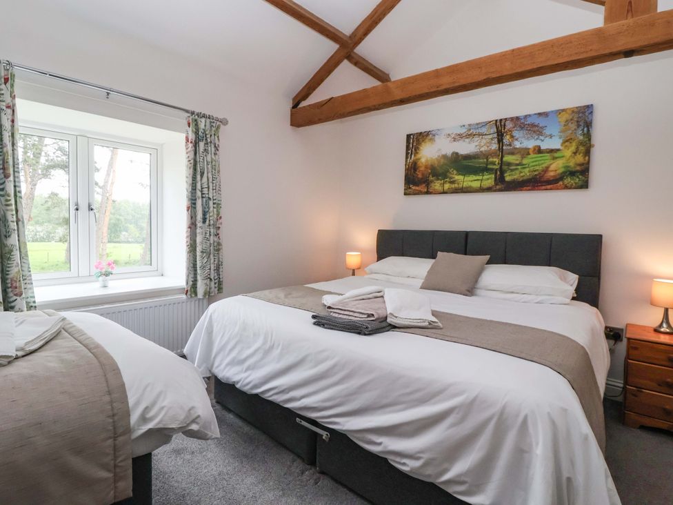 A bedroom with two beds and a window at Ploughman's Rigg Follifoot near Spofforth