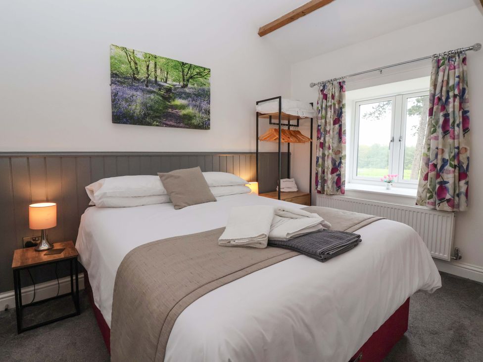 A bedroom with a bed and wardrobe at Ploughman's Rigg Follifoot near Spofforth