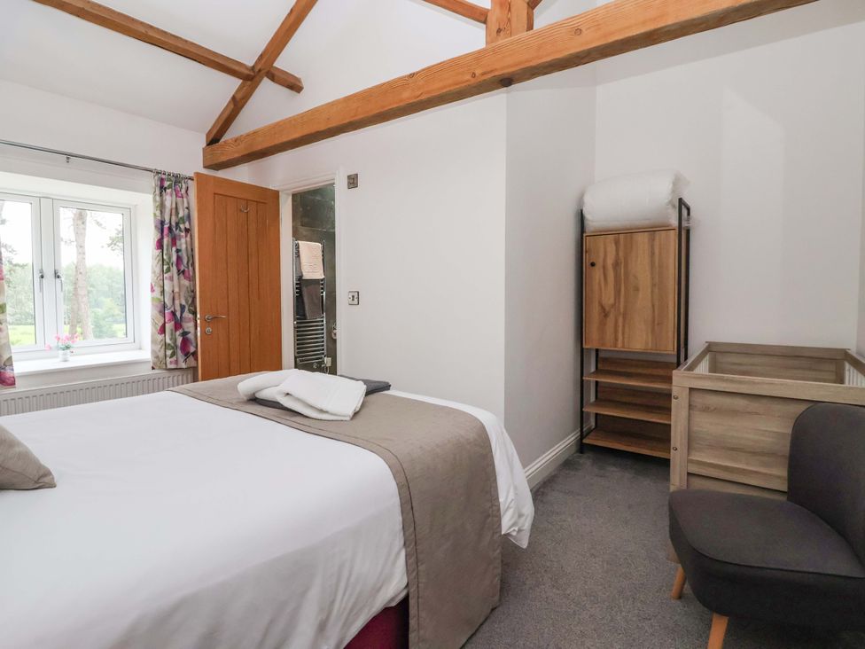 A bedroom with a bed and window at Ploughman's Rigg Follifoot near Spofforth