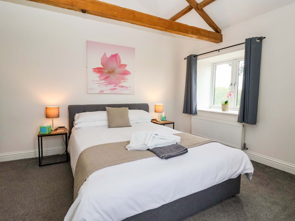 A bedroom with a bed and a window at Ploughman's Rigg in Follifoot near Spofforth