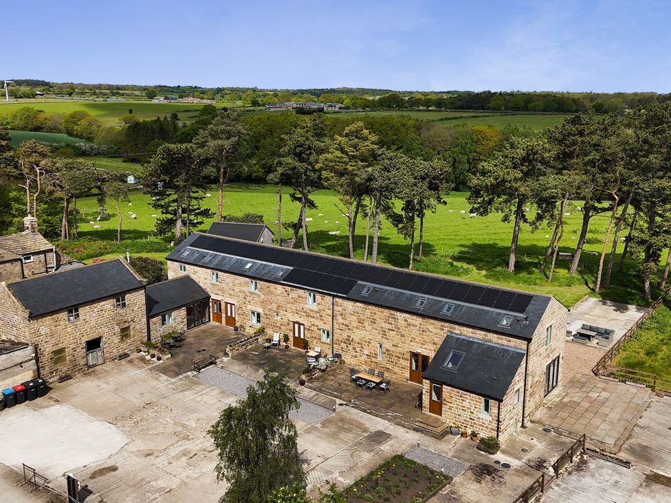 An outdoor space with buildings and greenery at Ploughman's Rigg in Follifoot near Spofforth