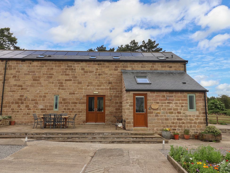 A building with solar panels and a patio area at Ploughman's Rigg in Follifoot near Spofforth