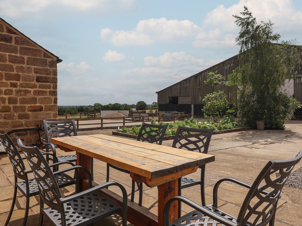 A wooden table with chairs in an outdoor setting at Ploughman's Rigg Follifoot near Spofforth