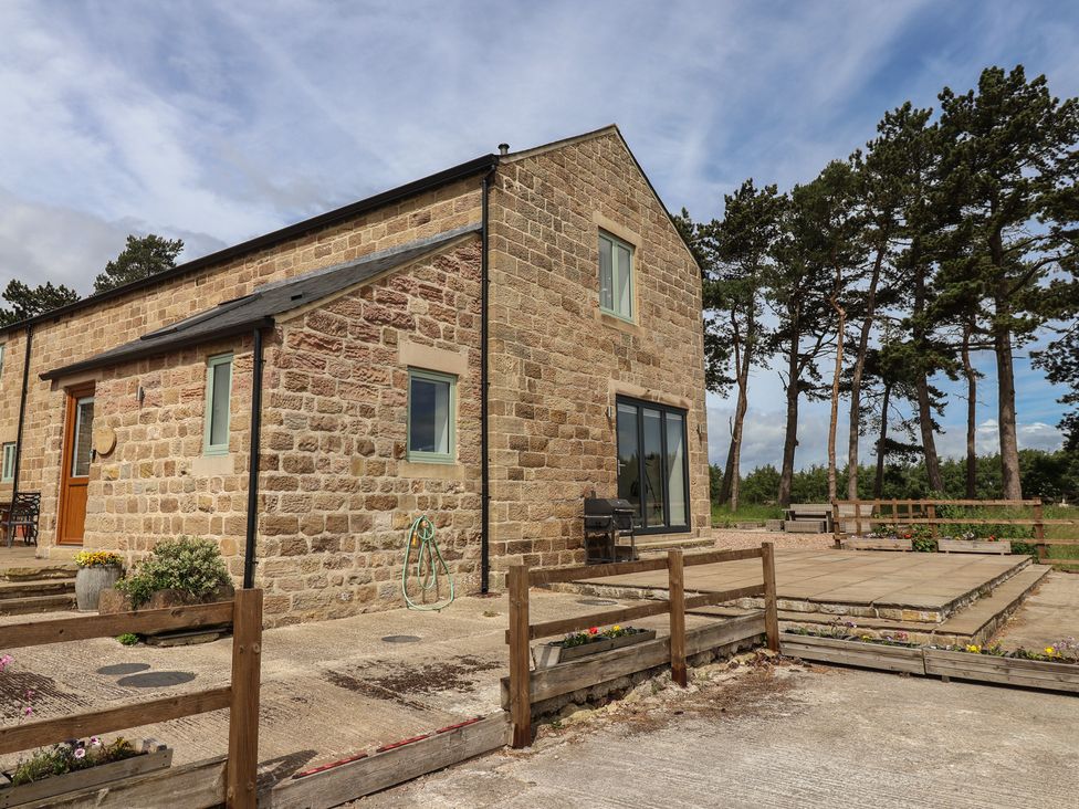 A stone house with a patio and garden at Ploughman's Rigg Follifoot near Spofforth