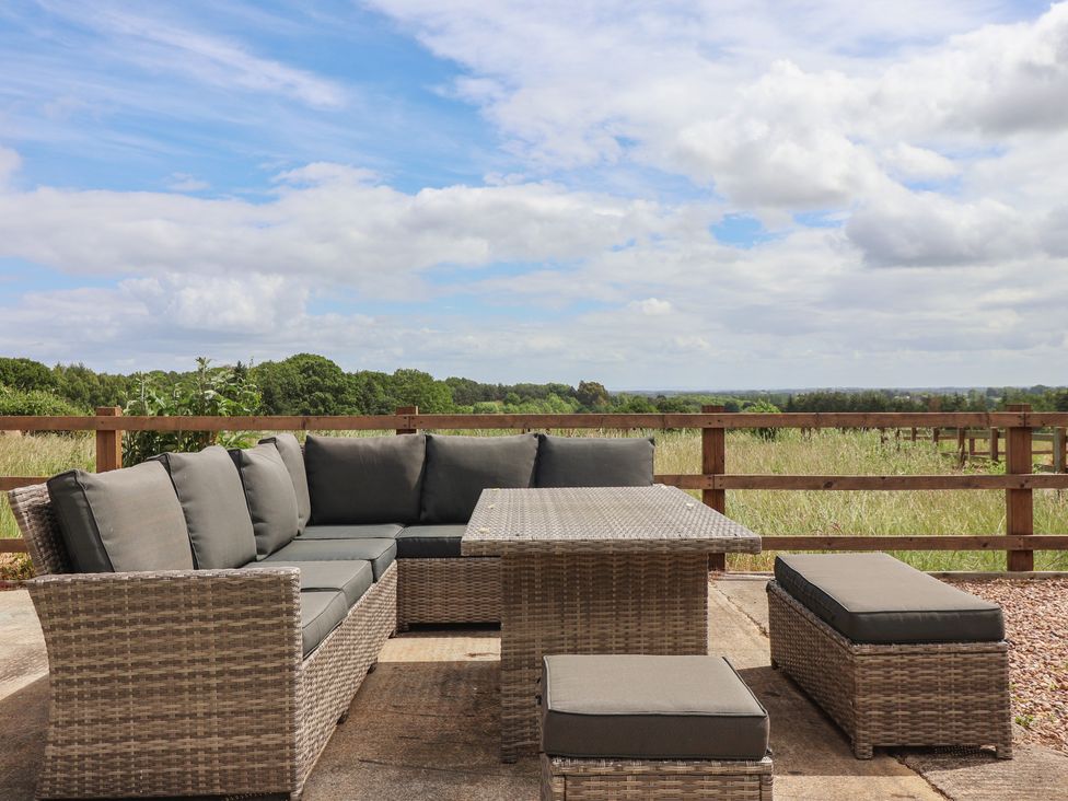 An outdoor seating area with a sofa and table at Ploughman's Rigg in Follifoot near Spofforth