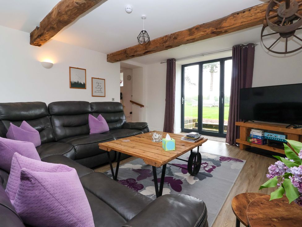 A living room with a sofa and coffee table at Miller's Wheel in Spofforth