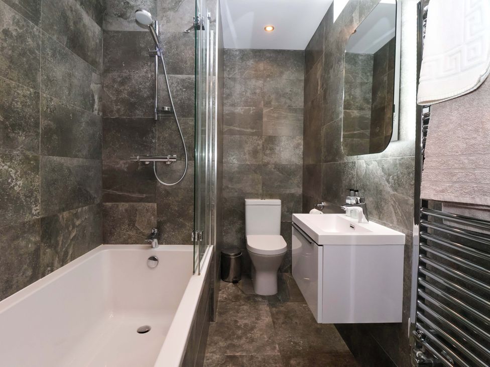 A bathroom with a shower, bathtub, toilet, and sink at Miller's Wheel in Spofforth