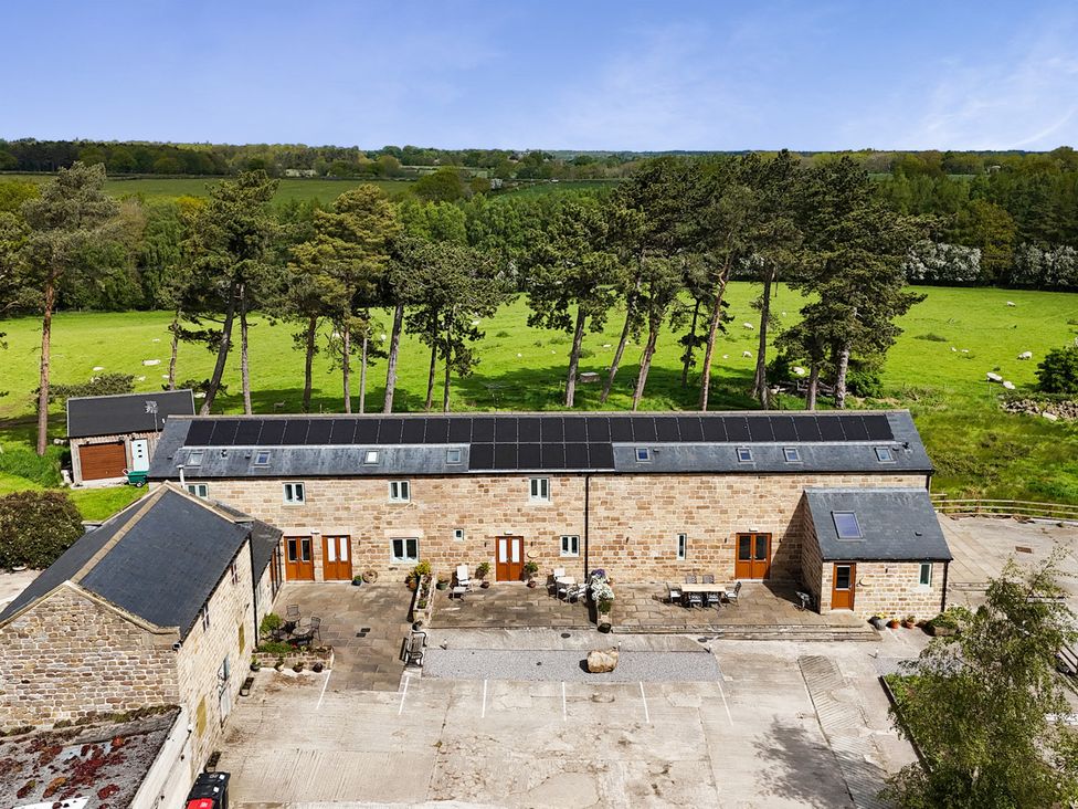 An outdoor view of a stone building with solar panels at Miller's Wheel in Spofforth