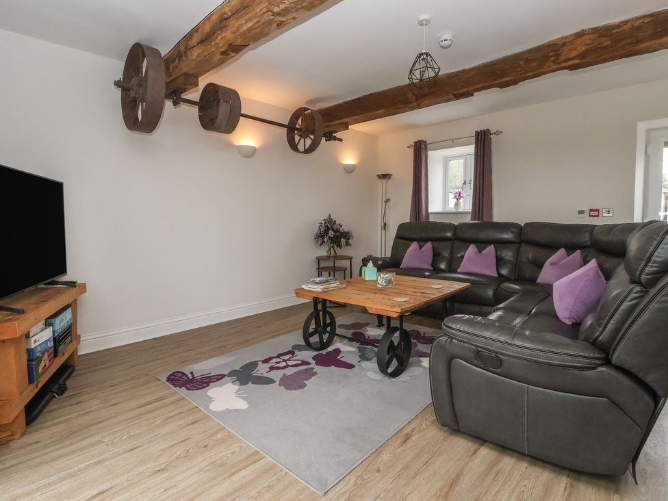 A living room with a sofa and coffee table at Miller's Wheel in Spofforth