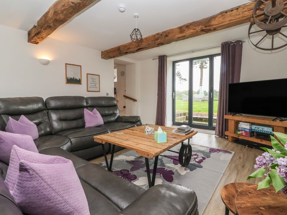 A living room with a sofa and coffee table at Miller's Wheel in Spofforth