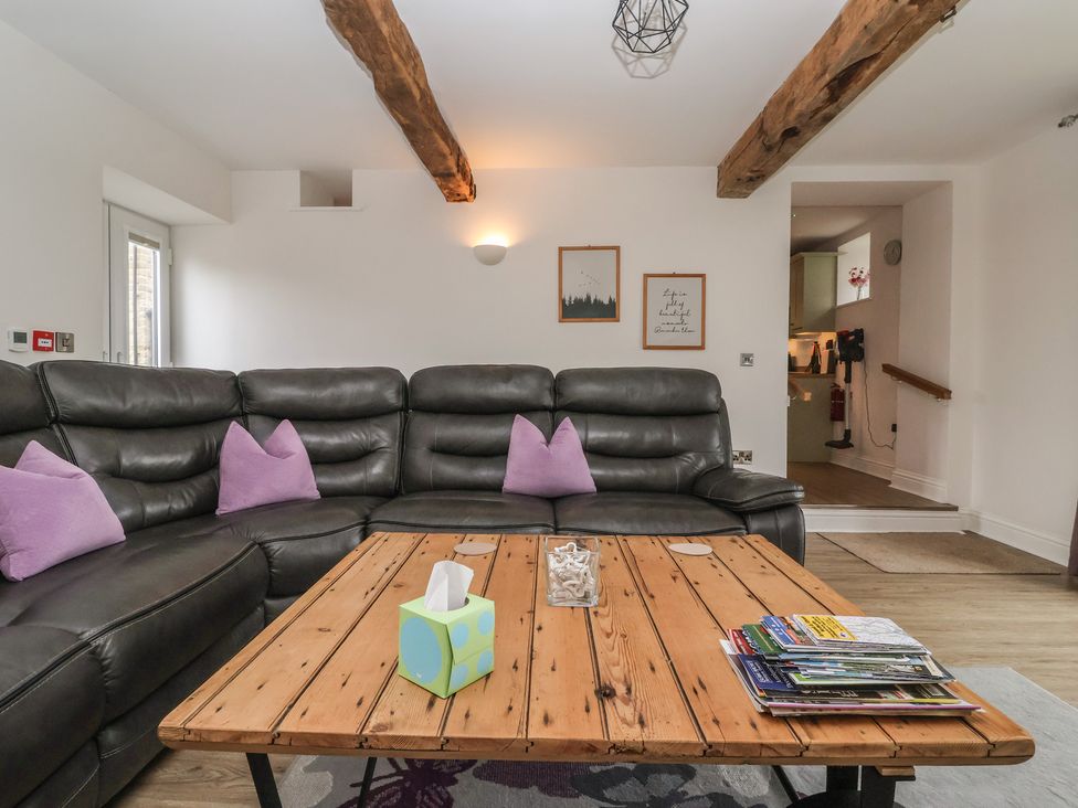 A living room with a sofa and coffee table at Miller's Wheel in Spofforth