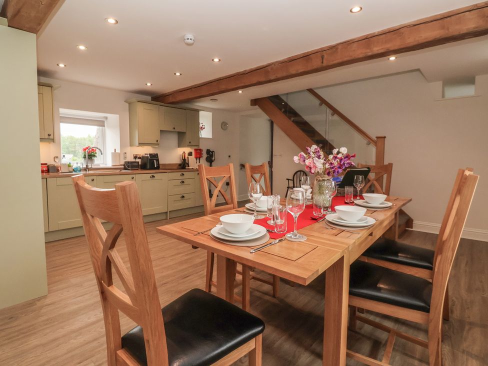 A dining room with a wooden table set for a meal at Miller's Wheel in Spofforth