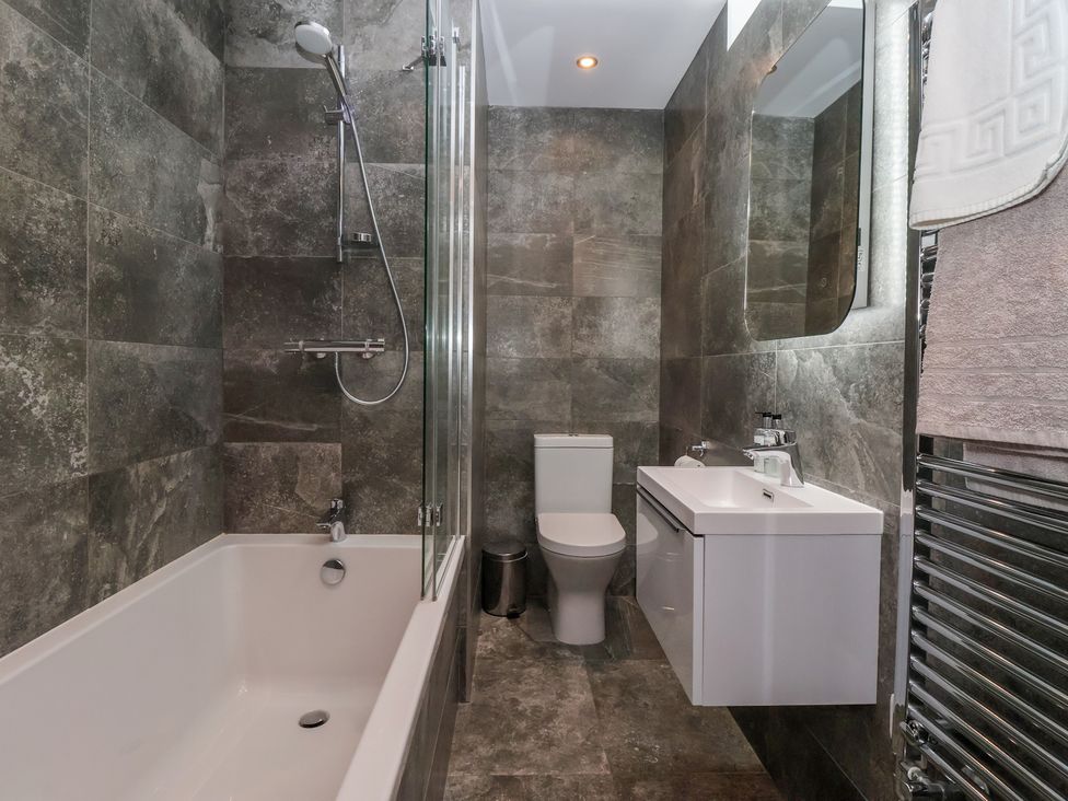 A bathroom with a bathtub and shower at Miller's Wheel Spofforth