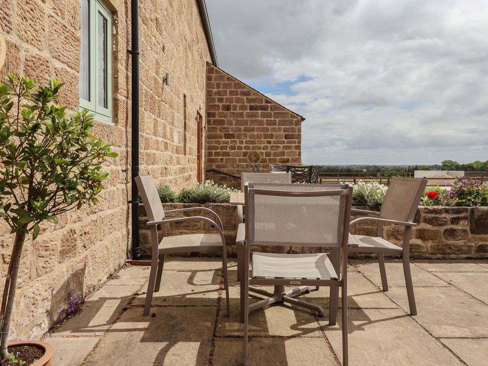 An outdoor patio with a table and chairs at Miller's Wheel in Spofforth