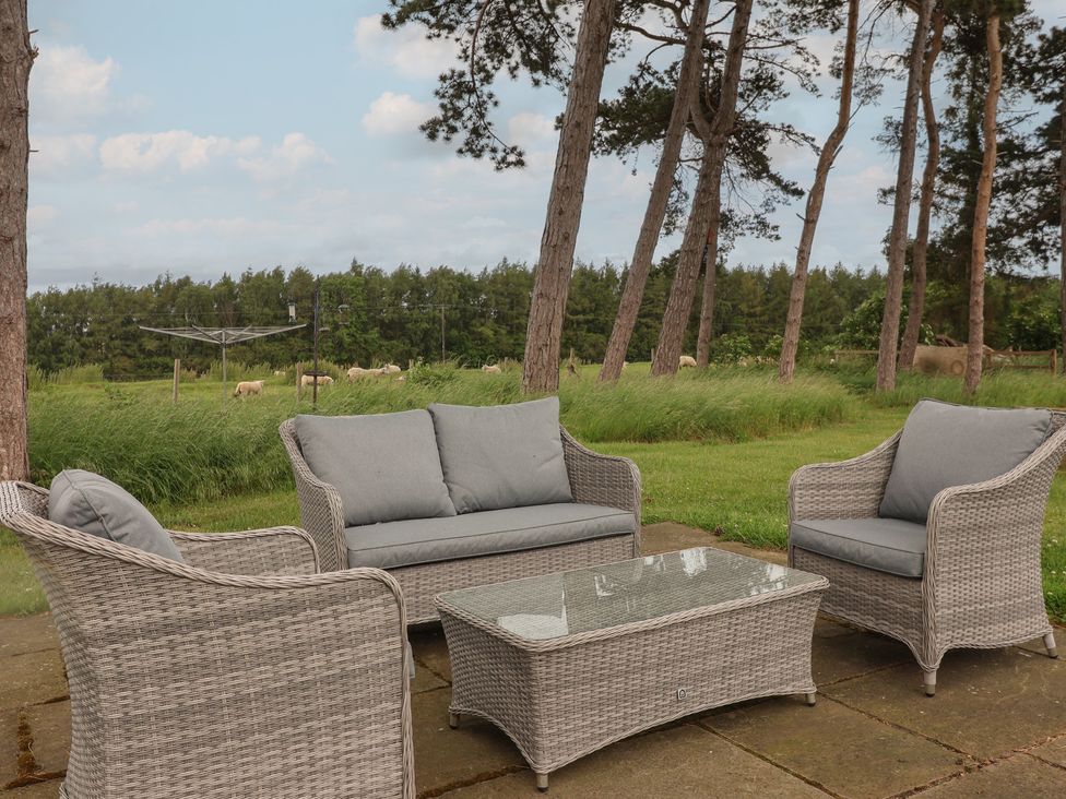 An outdoor seating area with a sofa and chairs at Miller's Wheel in Spofforth