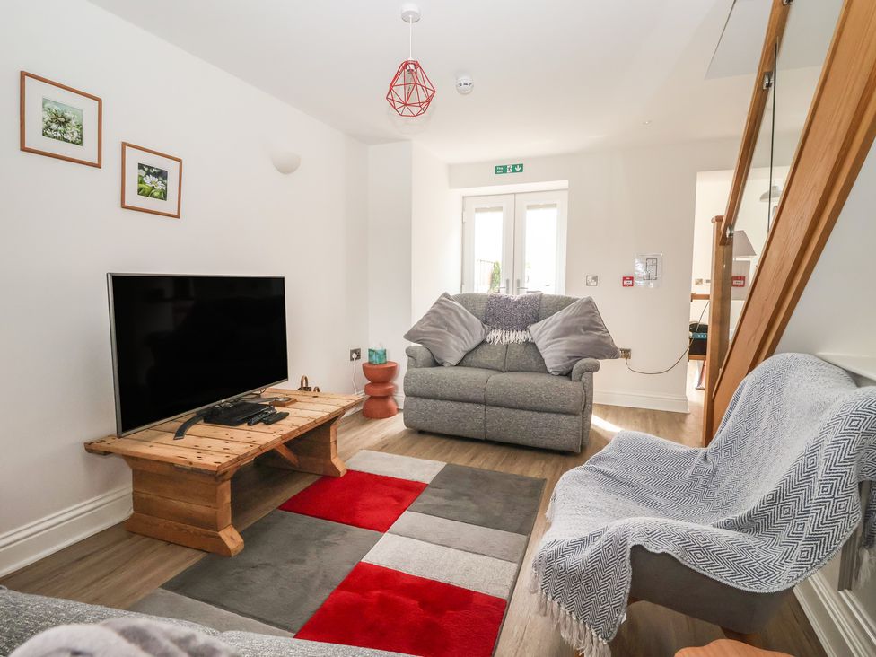 A living room with a television and sofa at Shepherd's Crook in Follifoot near Spofforth