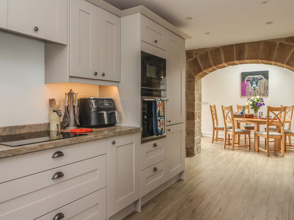 A kitchen with cabinets and a dining area at Shepherd's Crook in Follifoot near Spofforth