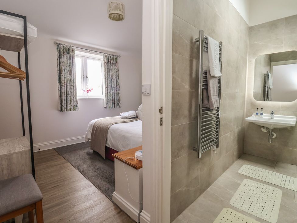 A bedroom with a bed and a sink at Shepherd's Crook in Follifoot near Spofforth