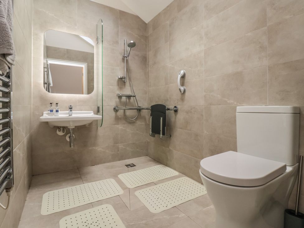 A bathroom with a sink, toilet, and shower at Shepherd's Crook Follifoot near Spofforth