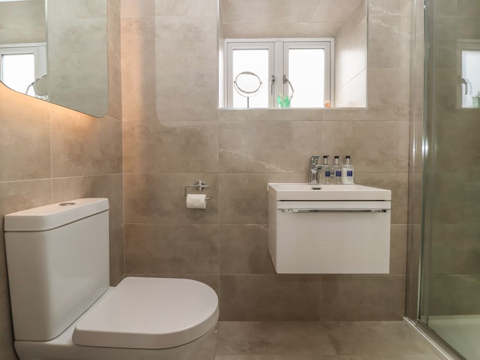 A bathroom with a toilet and sink at Shepherd's Crook in Follifoot near Spofforth